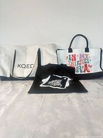 Three tote bags grouped together to show quantity and relative sizes