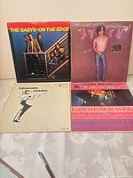 Group shot of all four LP covers on table