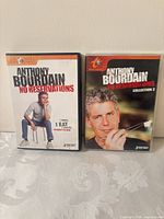 Front covers of Anthony Bourdain No Reservations Collection 1 and 2 sealed DVDs