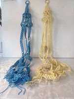 Both blue and cream macramé hangers full view