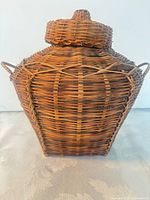 Front view showing basket shape, lid, and side handles