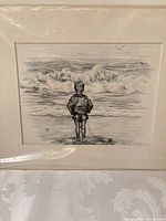 Full view of framed ink drawing showing child on beach scene