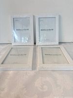 four wrapped white 5x7 frames front view