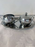 Sugar bowl with lid and creamer on oval tray
