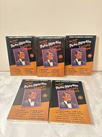 Group shot of five shrink-wrapped tapes, volumes visible