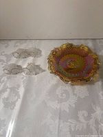 Amber carnival glass bowl and six clear bell ornaments overview