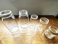 Five Mason jars lined up showing size comparison