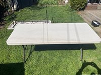 Top view of rectangular folding table set up on lawn