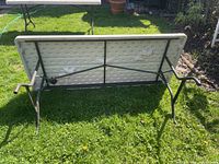 Underside of folded table showing steel frame and leg mechanism