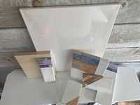 Group view of all canvases and wood panel standing together