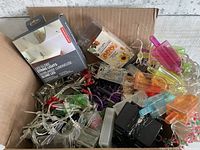 Open box showing assorted LED string lights and two packaged sets