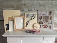 All items grouped: panels, prints, iron sign, frame, embroidery hoop, straws