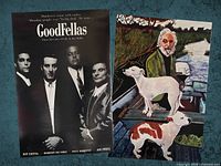 GoodFellas poster beside illustrated dogs on boat poster