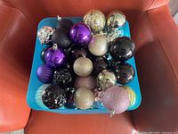 Bucket showing assortment of Christmas ball ornaments