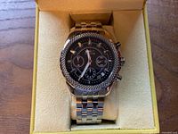 Watch in box, black dial visible