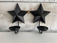 Front view of both star sconces showing shape and finish