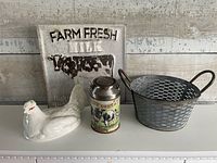 Group shot showing all four items: sign, basket, tin milk can, ceramic hen
