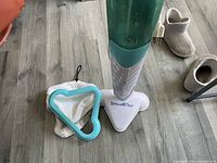 SteamTek steam mop with two cloth pads on floor