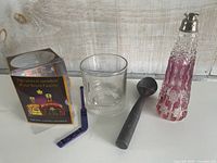 Group shot: perfume bottle, Crown Royal box, tumbler, swizzle stick, ice cream scoop