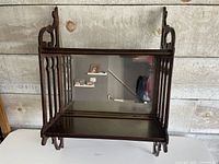 Front view showing both tiers, mirror, fretwork sides