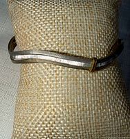 Full view of flat tri-tone bangle on cushion