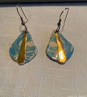 Front view of both earrings showing swirl pattern and gold stripe