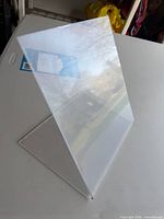 Side view of clear slanted acrylic sign holder