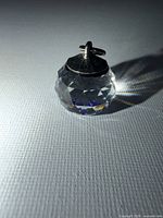 front view of faceted crystal pendant standing upright