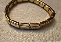 Full view of gold-tone Italian charm bracelet showing all links