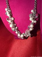 Front view of entire necklace on display bust