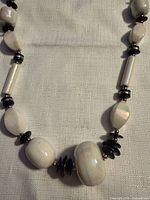 close view of assorted white stone beads and black spacers