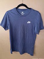 Front view of blue Nike t-shirt showing logo