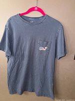Front view of Vineyard Vines slate-blue pocket T-shirt on hanger