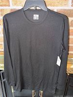 Full view of black long-sleeve shirt on hanger