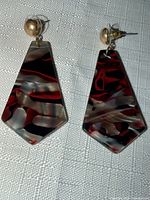 Front view of both acrylic drop earrings showing swirl pattern and gold-tone studs