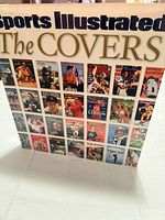 Front of hardcover coffee table book showing title and collage of magazine covers