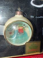 Front view of boxed 1978 Hallmark Tree-Trimmer ornament showing design and label