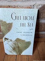 Front cover showing title, author, seashell artwork