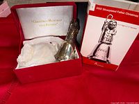 Bell ornament standing by presentation box and outer sleeve