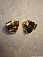 front view of both gold-tone knot earrings