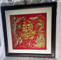 Frontal view of entire framed embroidery showing design, mat and frame