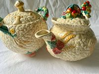 Teapot and biscuit jar front view showing basketweave texture and fruit relief