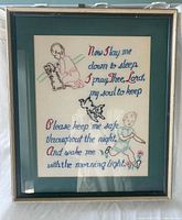 Full view of framed embroidery showing frame, mat, and entire design