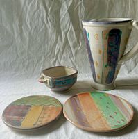 Group shot showing pitcher, bowl and two plaques with pastel abstract decoration