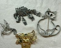 Group shot of all four brooch pins