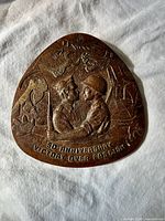 obverse showing soldiers, inscription, relief imagery