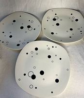 Three Midwinter Pierrot plates front view showing pattern