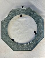 Front view showing octagonal shape and embossed floral design