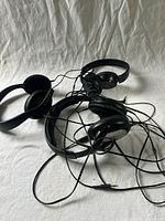 All three headphones tangled together showing overall condition