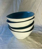 Stack of four handmade ceramic bowls showing exterior and interior glaze
